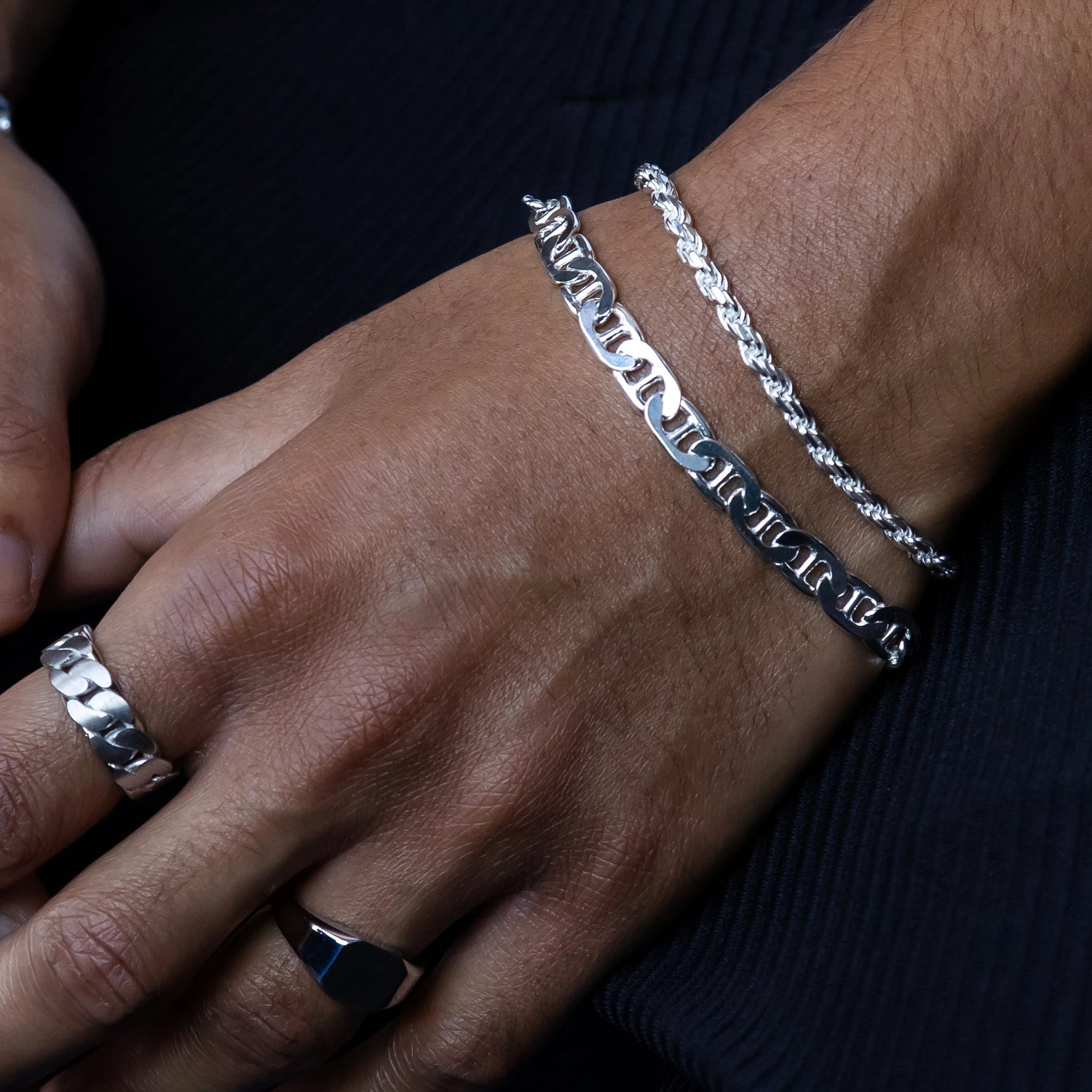 925 silver mariner link bracelet stacked with 925 silver diamond cut rope chain close up