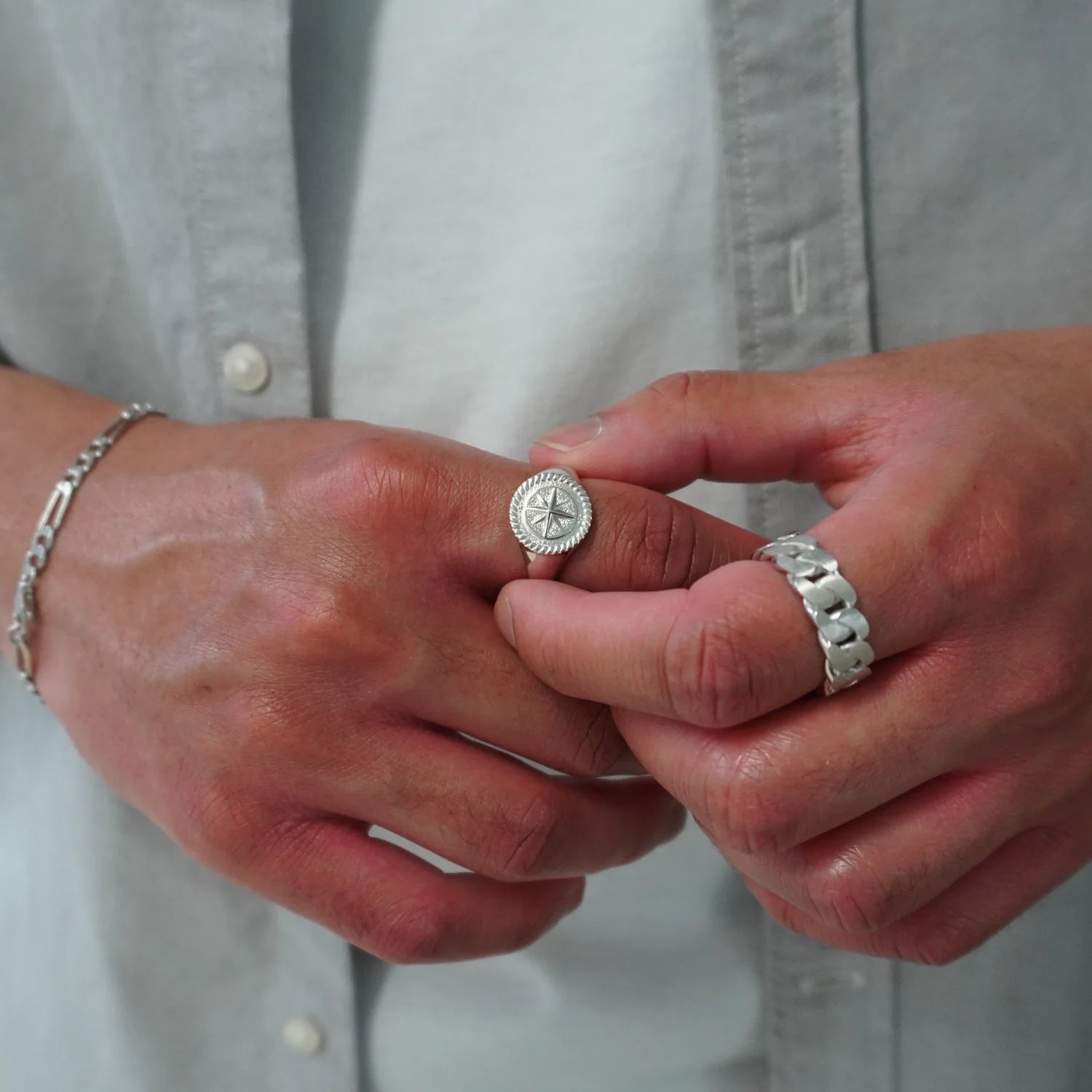 front angle of sterling silver compass ring and sterling silver cuban ring