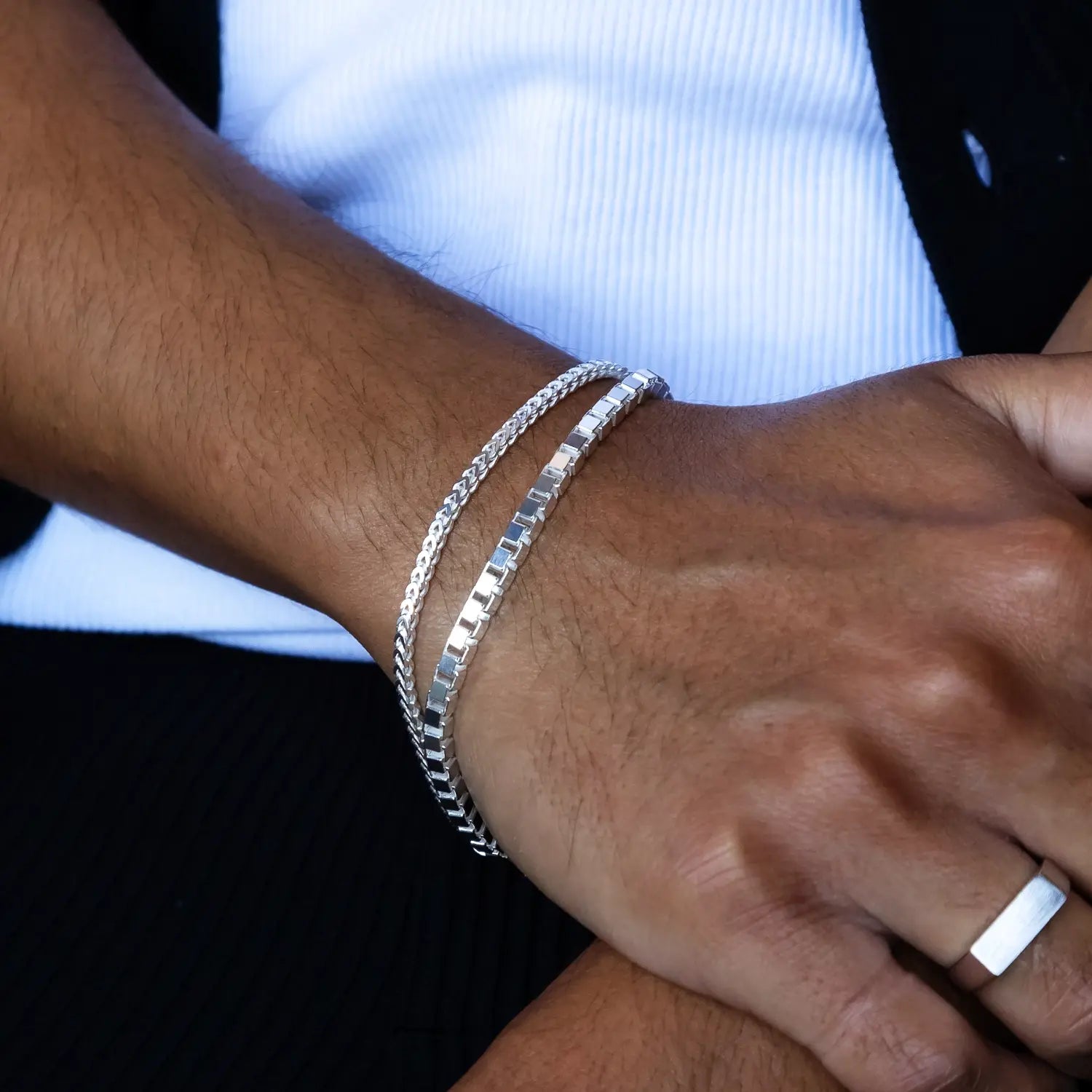 sterling silver franco bracelet stacked with 925 silver box chain bracelet on hands